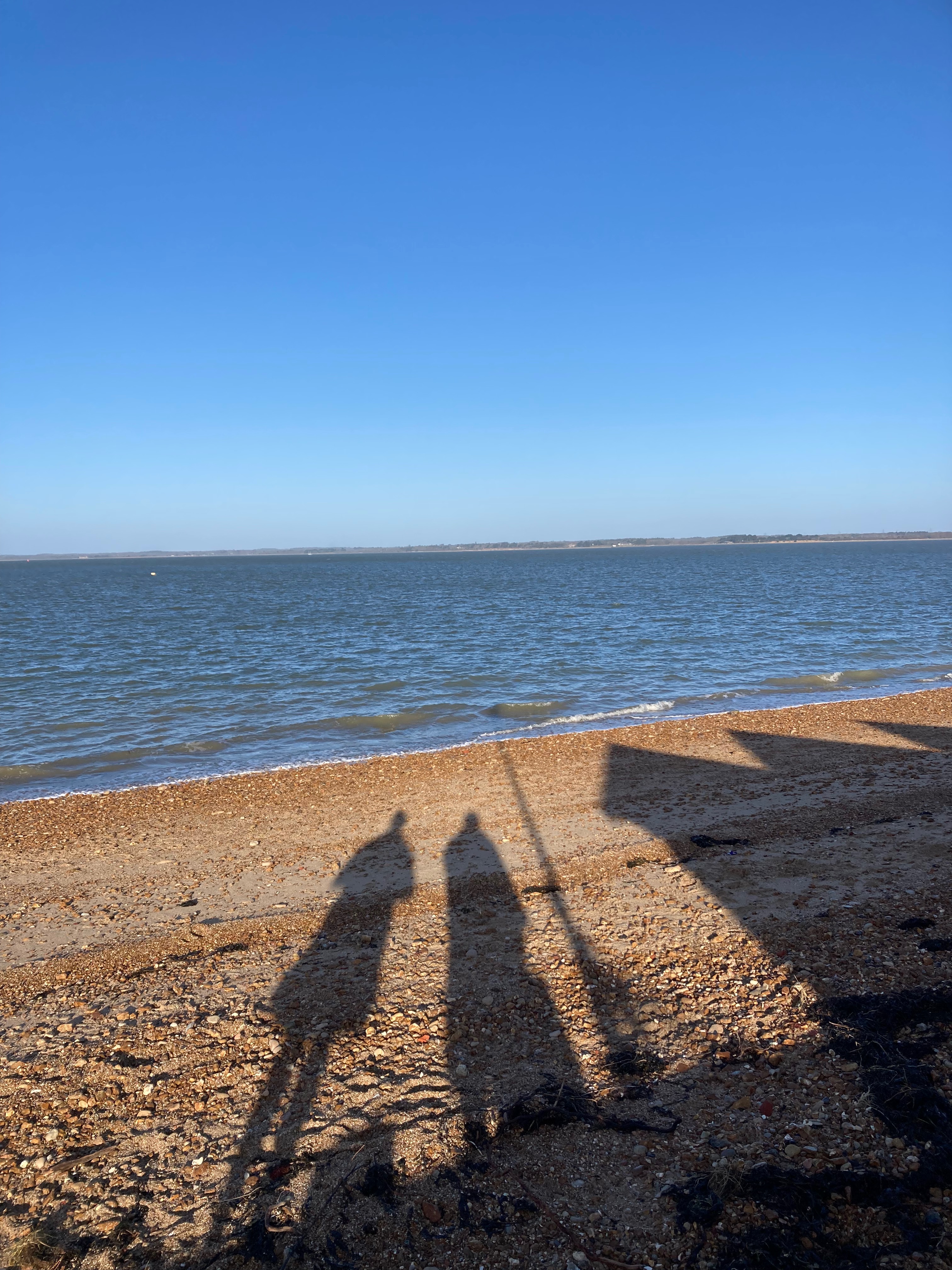 orange hat ladies, long shadows, sea swimming
